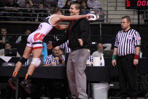 Zack Cooper jumps to coach Cliff Sandee after winning his third wrestling state championship. Photo/Joseph Van Harken 