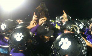 Shelby players celebrate with the district title trophy, its second in as many years. Photo/Mark Lewis