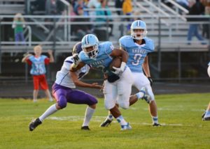 DeOntay Moffett rushes the ball up field for Mona Shores. Photo Eric Stuff