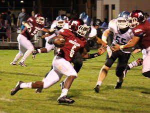 Alquan Evans rushes the ball up field for Muskegon. Photo/Jason Goorman