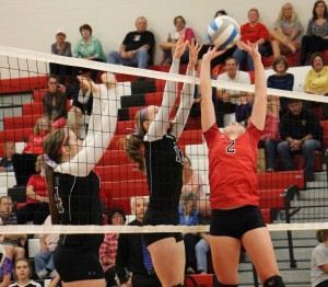 Whitehall's Andie Bolles makes a set over Shelby's No. 14 Megan Bell and No. 10 Chloe Sillman. Photo/Jason Goorman