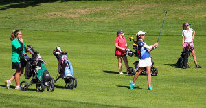 Mona Shores golfer Rylee George takes her second shot on No. 11 while Reeths-Puffer's Mikaela VanDuinen (green shirt), Whitehall's Taylor Mikkelson (red shirt) and Western Michigan Christian's Abbie Alfrey watch. Photo/Jason Goorman