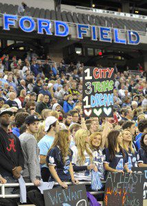 Sailor fan Morgan Smith’s sign shows the Muskegon community pride of having 3 local teams at Ford Field.