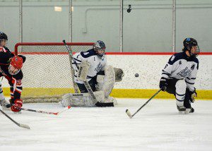Mona Shores sophomore goalie Anthony Shrum (1) absorbs a shot on his way to a 15 save shutout versus rival East Kentwood.  Photo/Eric Sturr