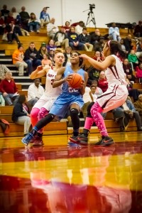 Mona Shores #22 Jordan Walker drives to the hoop against Muskegon #3Shawnteanna Dame photo/Tim Reilly