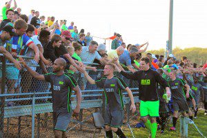 Fans line up to give the Muskegon Risers a highfive after winning their first ever match. Photo/Jason Goorman