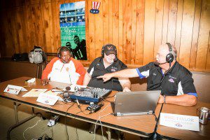 Muskegon Heights head football coach Tommy Elliot talks with radio hosts John Russel and Cal VanSingle. Photo/Tim Reilly