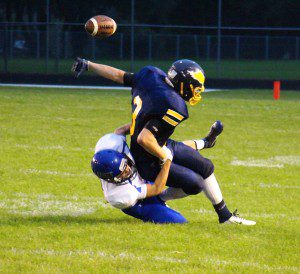 David Thompson strips the ball from North Muskegon's No. 3 Andrew Butzow. Photo/Jason Goorman