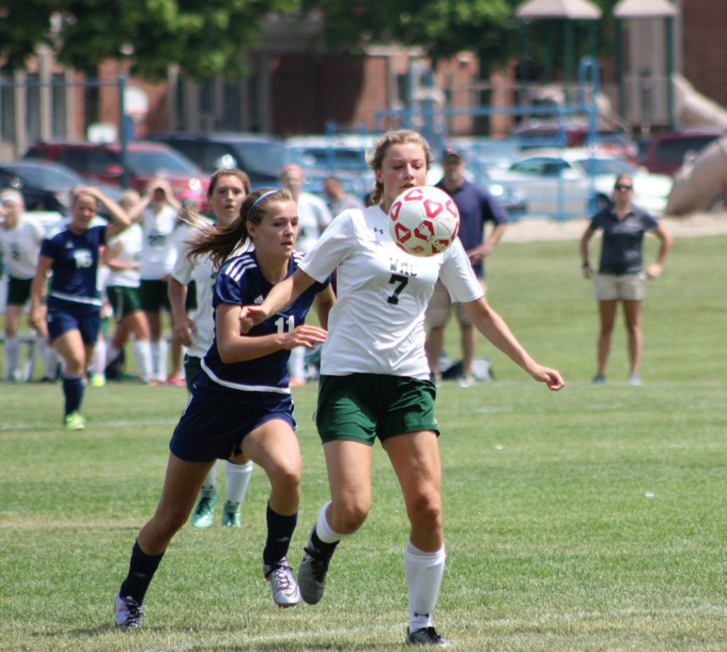 Lauren Myers is chased by North Muskegon's Ayla Pitts. Photo/Jeff Erickson