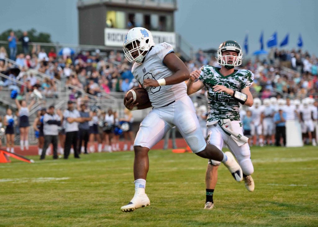 Marcus Collins (3) gets past Collin Houseman (2) for Mona Shores’ first TD. Photo/ Eric Sturr