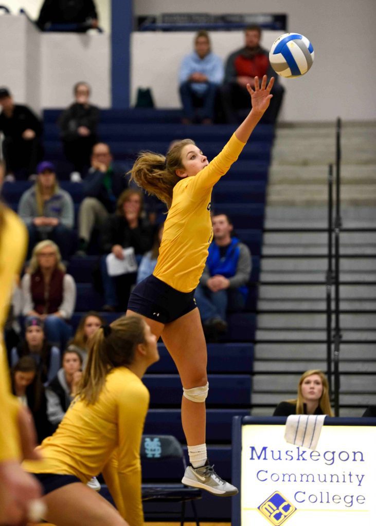 Grand Haven’s Olivia Boeve spikes from the outside. (photo/Eric Sturr)
