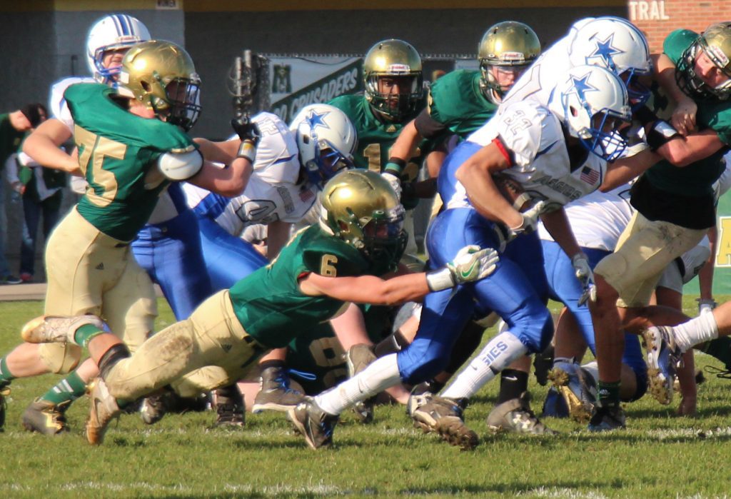 No. 6 Riley St. Amour stretches out to pull down Beal City runningback No. 32 Sam Fox. Photo/Jason Goorman