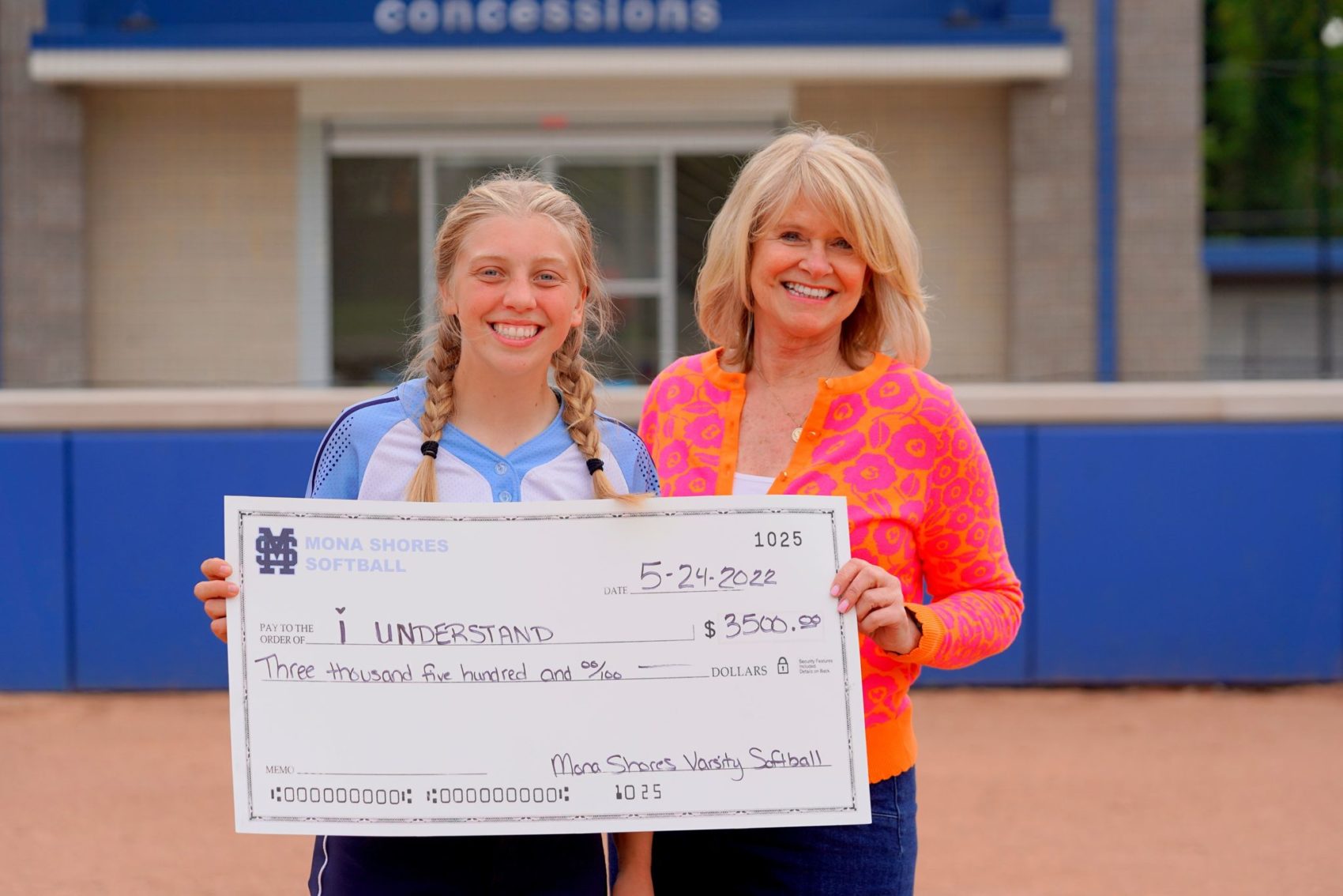 Mona Shores girls softball team presents $3,500 check to “I Understand”
